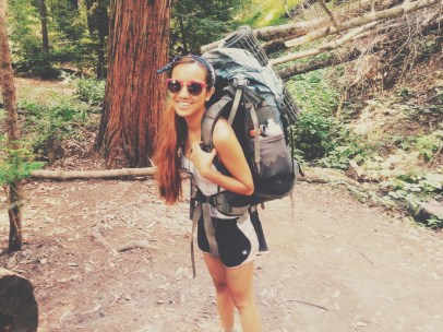 Happy as can be carrying a backpack improperly fit and wearing boots too small.